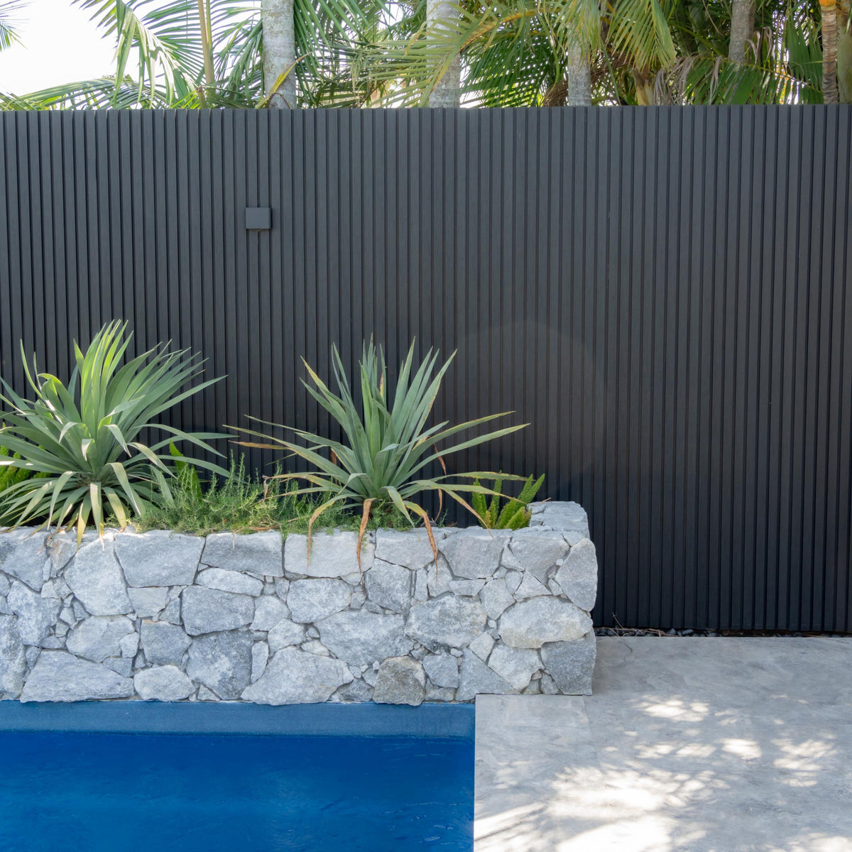 Black outdoor panels by the pool